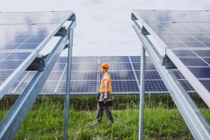 Man Worker In The Firld By The Solar Panels - 2